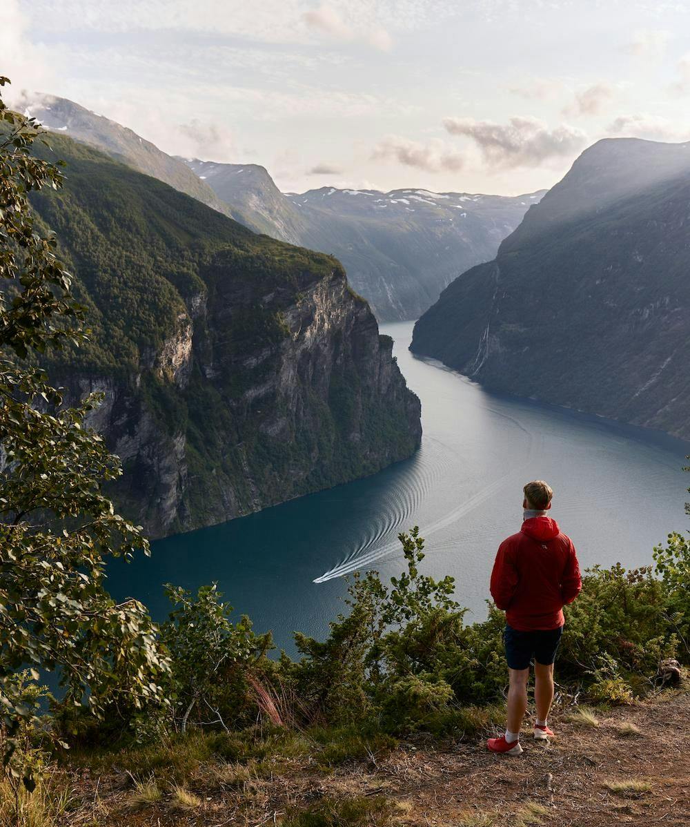 Man at viewpoint above fjord