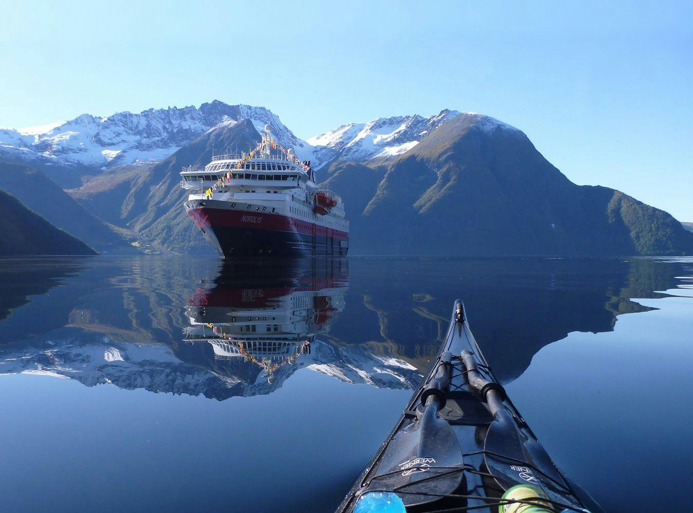 Coastal Express and kayak in a fjord