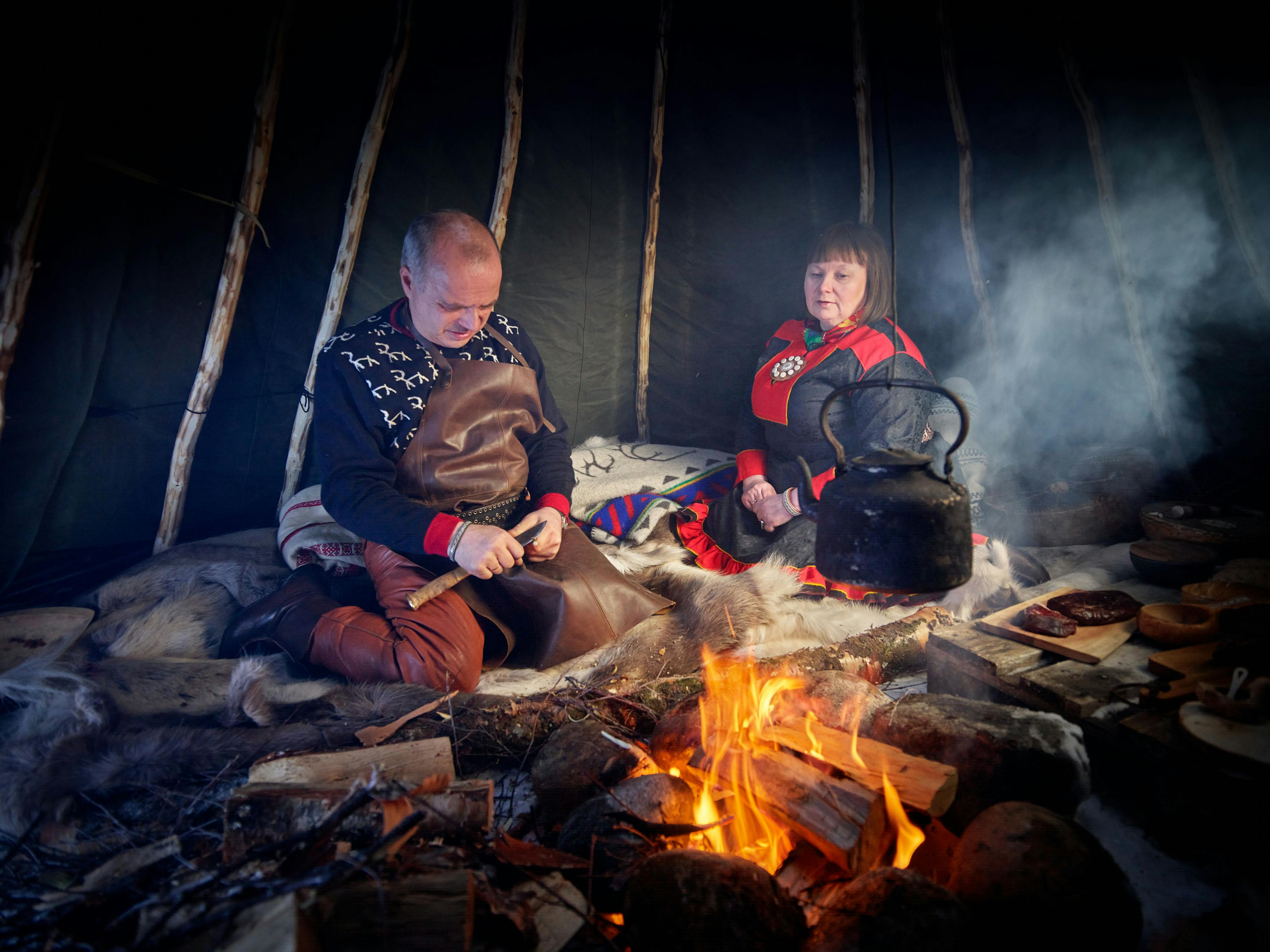 A Sami couple in front of the fire